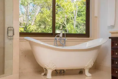 a bath tub in a bathroom with a window at Casa Puesta del Sol 5 bdr - Ocean View Family in La Mona