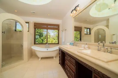 a bathroom with two sinks and a tub and a shower at Casa Puesta del Sol 5 bdr - Ocean View Family in La Mona