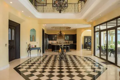 a kitchen and living room with a checkerboard floor at Casa Puesta del Sol 5 bdr - Ocean View Family in La Mona