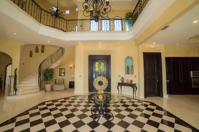 a large room with a checkered floor and a staircase at Casa Puesta del Sol 5 bdr - Ocean View Family in La Mona