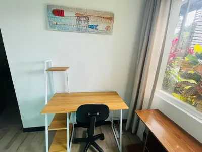 a desk with a chair next to a window at Beach Apartment with Pool and Lake - Playa Hermosa in Muñeco
