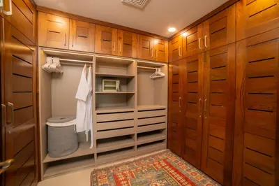 a walk in closet with wooden cabinets and a rug at Terrazas 1A - 3 bedroom - seven day minimum in La Mona