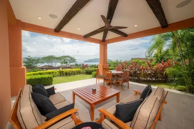 a screened in porch with a table and chairs at Terrazas 1A - 3 bedroom - seven day minimum in La Mona