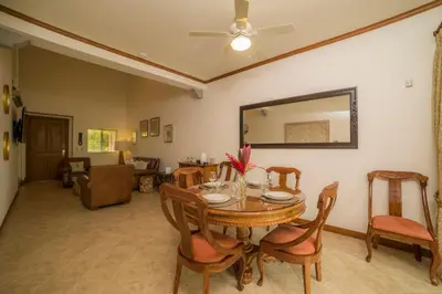 a dining room with a table and chairs and a mirror at Veranda 1C - 3 bdr 3 bath in La Mona
