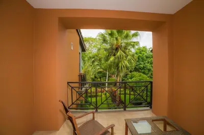 a room with a balcony with a view of a palm tree at Veranda 1C - 3 bdr 3 bath in La Mona