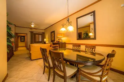 a dining room with a table and chairs and a mirror at Veranda 1E 3bdr 3 bath in La Mona