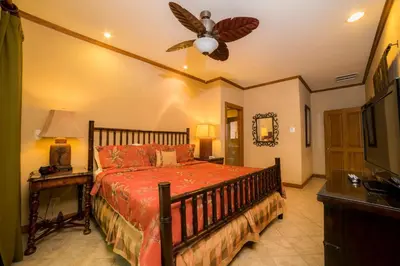 a bedroom with a bed and a ceiling fan at Veranda 1E 3bdr 3 bath in La Mona