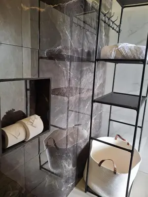 a room with a wall with shelves and a mirror at Casita El Perezoso in San Rafael