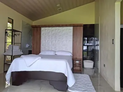 a bedroom with a large white bed with a canopy at Casita El Perezoso in San Rafael