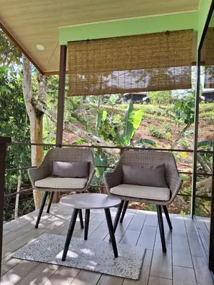 two chairs and a table on a porch at La Casita El Perezoso in San Rafael