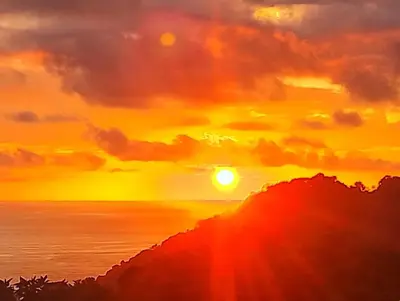 a painting of the sun setting over the ocean at Casa Pura Vista in Playa Hermosa