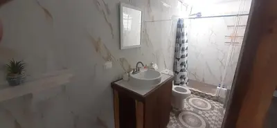a white bathroom with a sink and a toilet at Casa iguana in Potrero