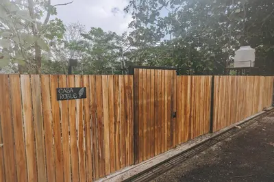 a wooden fence with a sign on it at CASA ROBLE, One-Bedroom with Pool in Paradise, Quiet and Fast WiFi in Santiago