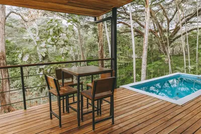 a deck with a table and chairs and a swimming pool at CASA ROBLE, One-Bedroom with Pool in Paradise, Quiet and Fast WiFi in Santiago