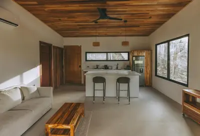 a kitchen and living room with a couch and a table at CASA ROBLE, One-Bedroom with Pool in Paradise, Quiet and Fast WiFi in Santiago