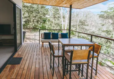 a deck with a table and chairs and a couch at CASA ROBLE, One-Bedroom with Pool in Paradise, Quiet and Fast WiFi in Santiago