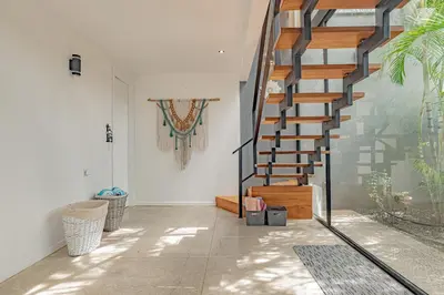 a hallway with a staircase in a house at Villa Bernard - luxurious home walking distance to the beach in Tamarindo