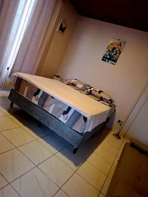 a bed sitting in a room with a window at My Costa Rica Home Place in Tetsalia