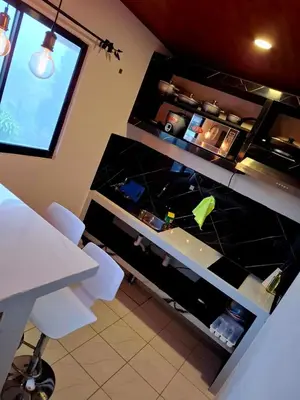 a kitchen with a table and two white chairs at My Costa Rica Home Place in Tetsalia