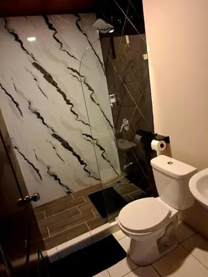 a bathroom with a shower and a toilet and a sink at My Costa Rica Home Place in Tetsalia