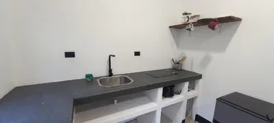 a kitchen counter with a sink in a room at Dynamis Retreat in Tamarindo