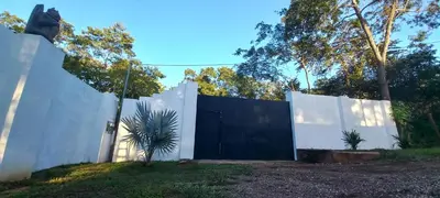 a white fence with a black gate at Dynamis Retreat in Tamarindo