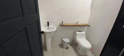 a small bathroom with a toilet and a sink at Dynamis Retreat in Tamarindo