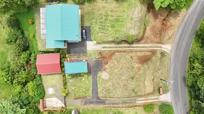an aerial view of a house with a blue roof at Villa Oropéndola Sarapiquí in Colonia Carvajal