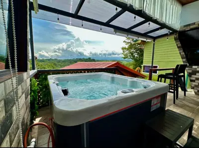 a hot tub on the patio of a house at Villa Oropéndola Sarapiquí in Colonia Carvajal