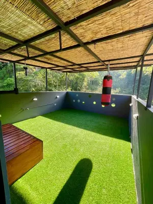 a room with a playground with green grass and a swing at Tesoro Escondido in Naranjito