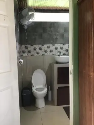a bathroom with a toilet and a sink at Apartamento Paseo Damitas in Parrita
