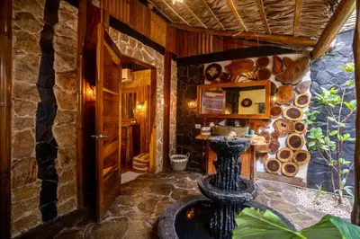 aoyer of a house with a stone wall at Ocho Artisan Bungalows in Tamarindo