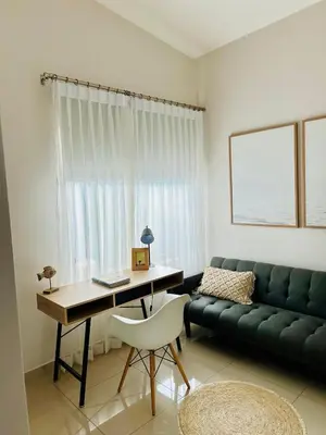 a living room with a desk and a green couch at Remote Work Haven 15 Minutes from the Beach in Sardinal