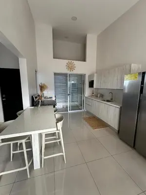 a kitchen with a table and a stainless steel refrigerator at Remote Work Haven 15 Minutes from the Beach in Sardinal
