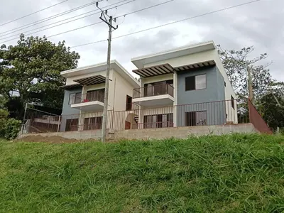 a building with balconies on the side of a hill at Vista Serena la Guácima in Alajuela City