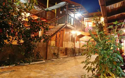 an empty courtyard of a building with a staircase at Hotel El Atardecer in Monteverde Costa Rica