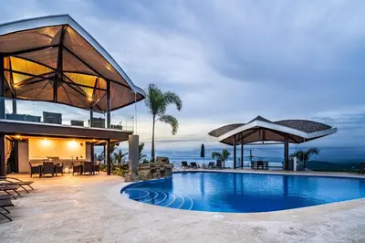 a villa with a swimming pool and a house at Mar a Mar 09-04C in Punta Leona