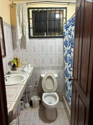 a bathroom with a toilet and a sink at Private Room One block from the beach in Coco