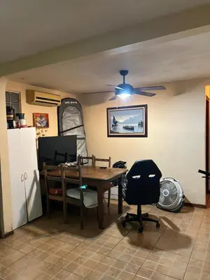 a dining room with a table and a ceiling fan at Private Room One block from the beach in Coco