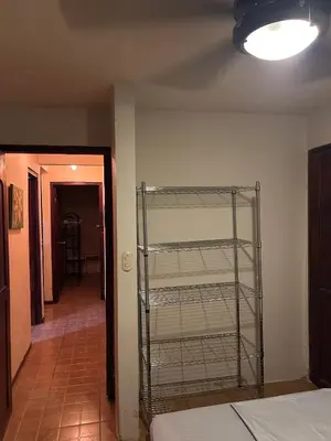 a room with a shelf in the corner of a room at Private Room One block from the beach in Coco