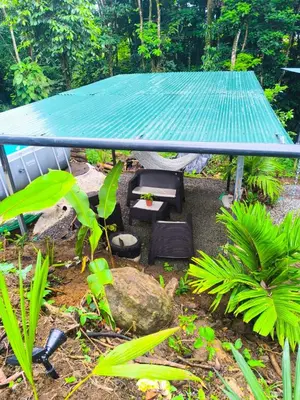 a picnic table and chairs in a garden at Monstera Forest Lodge in Fortuna