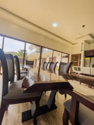a conference room with a wooden table and chairs at Casa Pura Vida in Coco