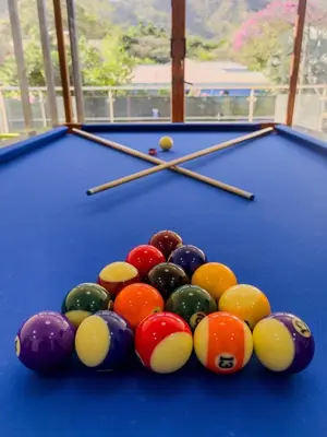 a group of balls on top of a pool table at Casa Pura Vida in Coco