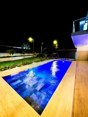 a swimming pool at night with blue water at Casa Pura Vida in Coco