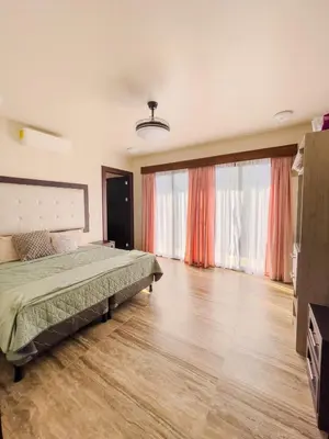 a bedroom with a bed and a large window at Casa Pura Vida in Coco