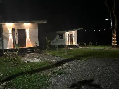 a small house at night with lights on it at Bungalows Chachagüita in Chachagua