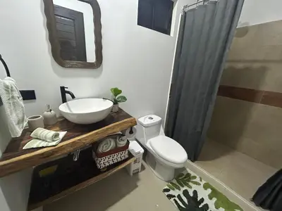 a bathroom with a sink and a toilet at Bungalows Chachagüita in Chachagua