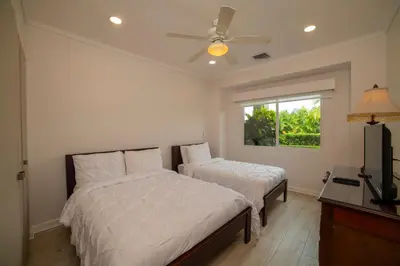 a bedroom with two beds and a ceiling fan at Del Mar 4M - 3 bdr 2 bath Condo in Herradura