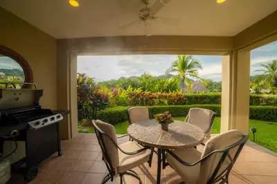 a dining room with a table and chairs and a window at Del Mar 4M - 3 bdr 2 bath Condo in Herradura
