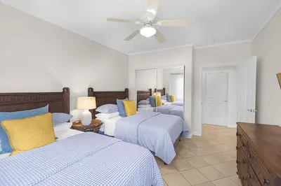 a bedroom with three beds and a ceiling fan at Del Mar 5F 3 bedr 2 bath in Herradura